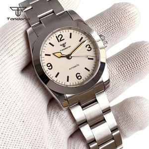 Silver wristwatch with white face on a textured surface, featuring the Tandorio brand.